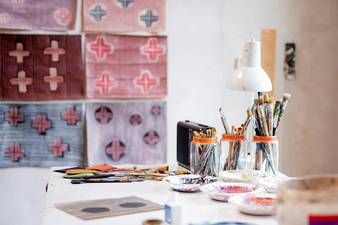 Materials and brushes on an artist’s worktable — editorial photograph
