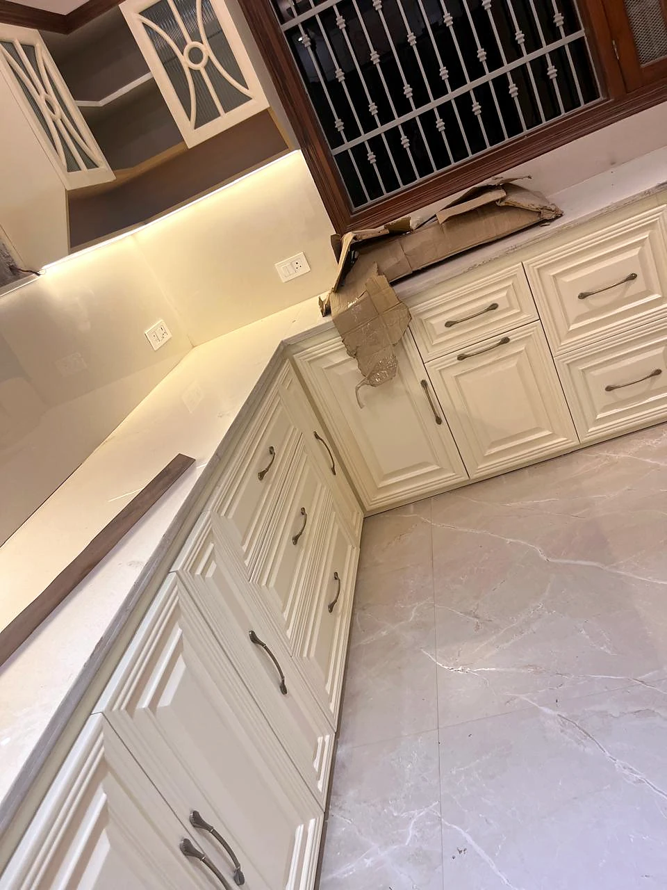 Overhead perspective of the pale L-shaped kitchen counter and built-in cabinetry