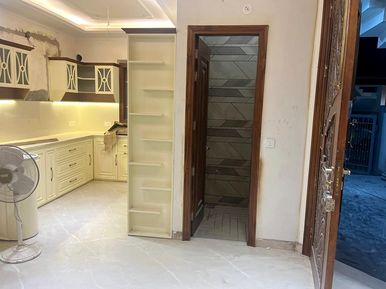 View from the kitchen toward pantry storage and the adjoining passage