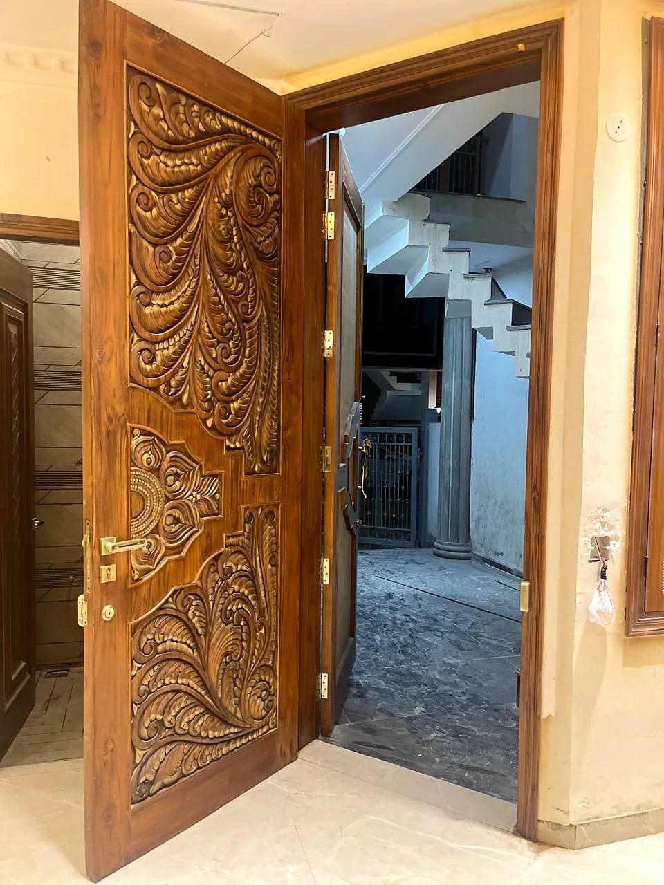 Carved timber door opening toward the stair landing