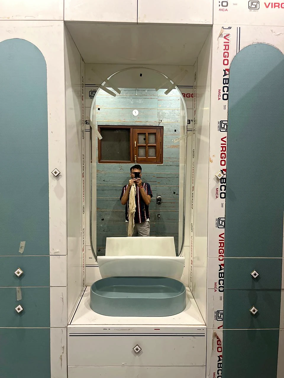 Mirror and basin vanity in a tiled washroom