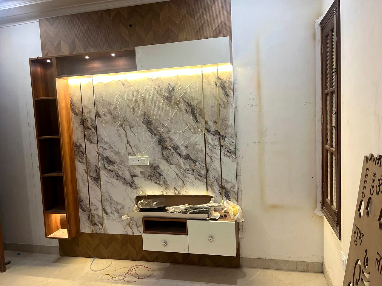 Marble-look media backdrop with floating console and warm shelf lighting