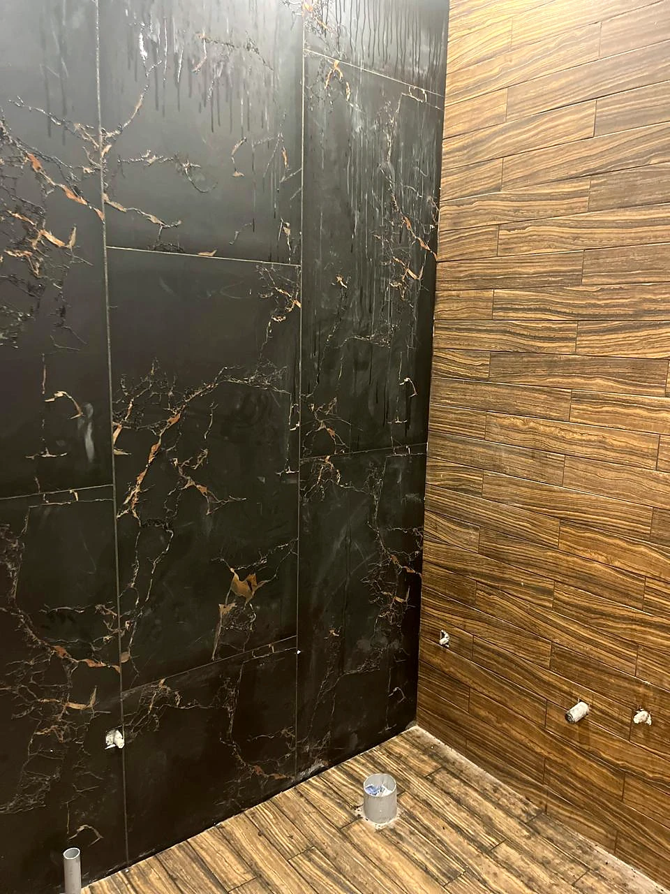 Dark stone-look wall meeting textured wood cladding