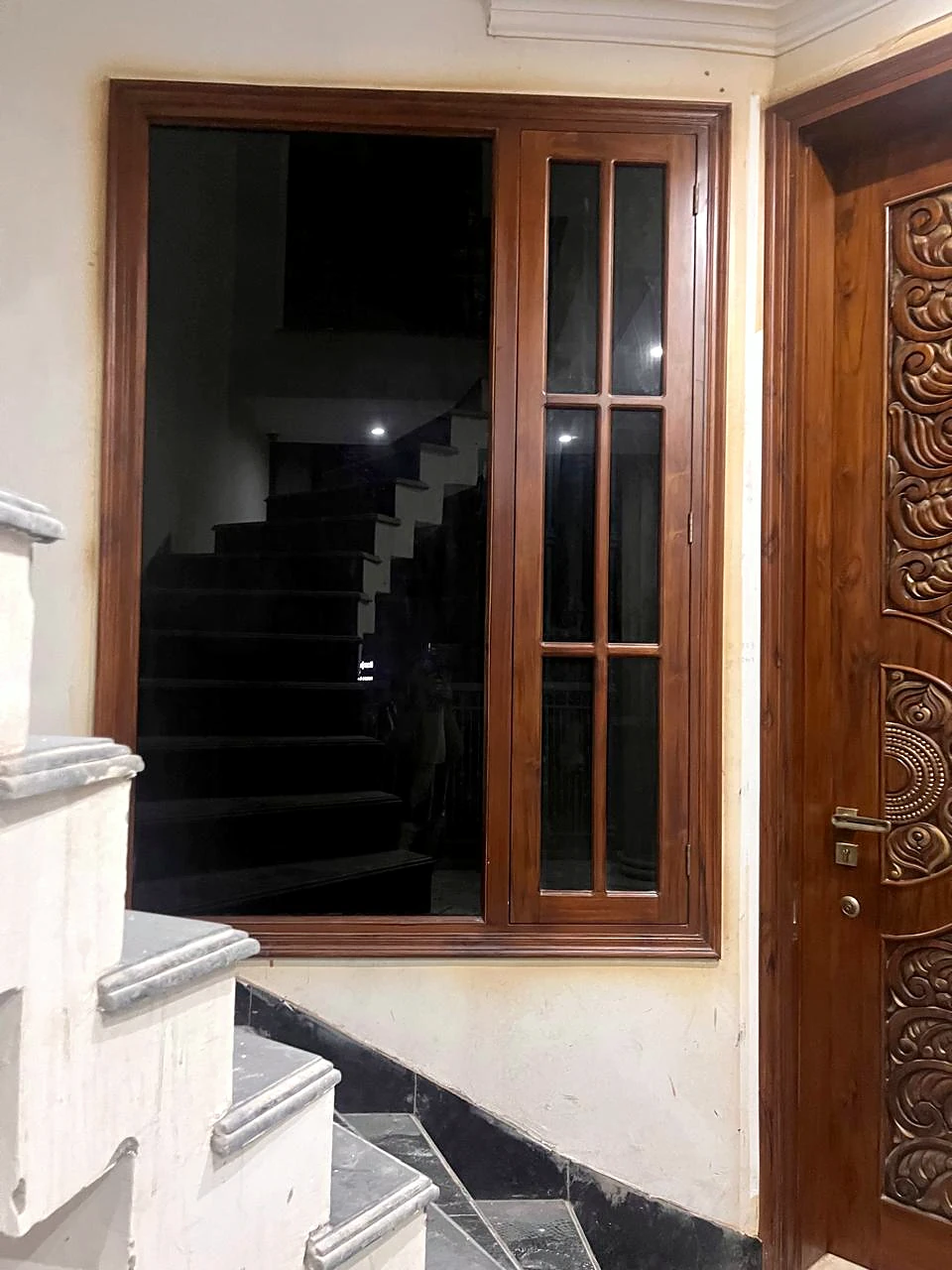Stairway landing with a dark-framed window