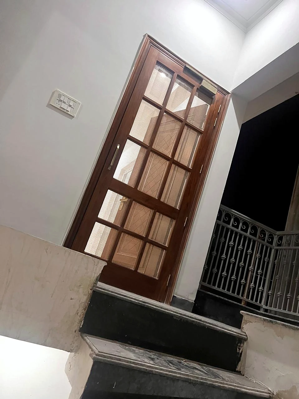 Staircase window with dark timber framing and tiled steps