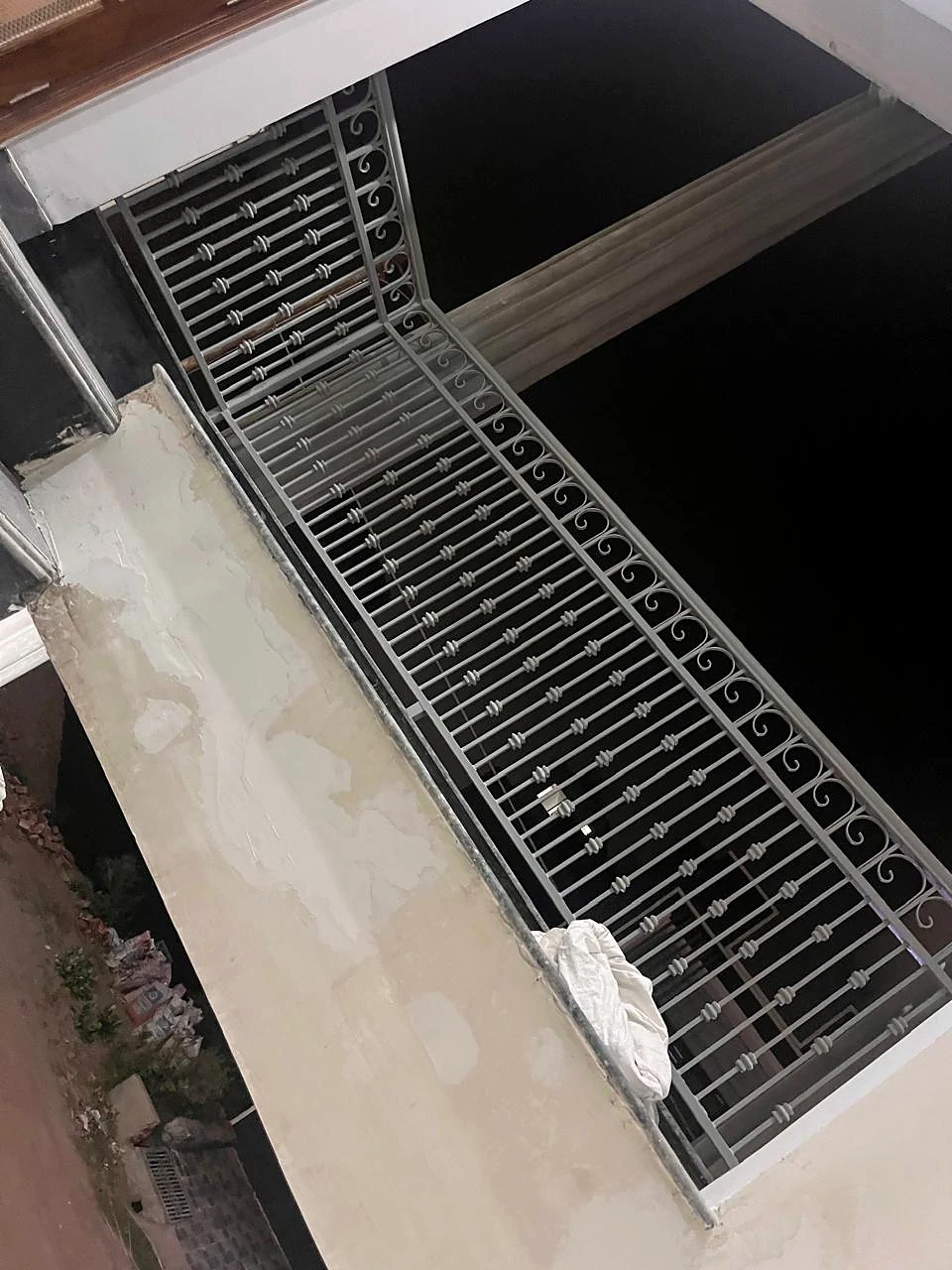 Exterior metal gate photographed from above during installation