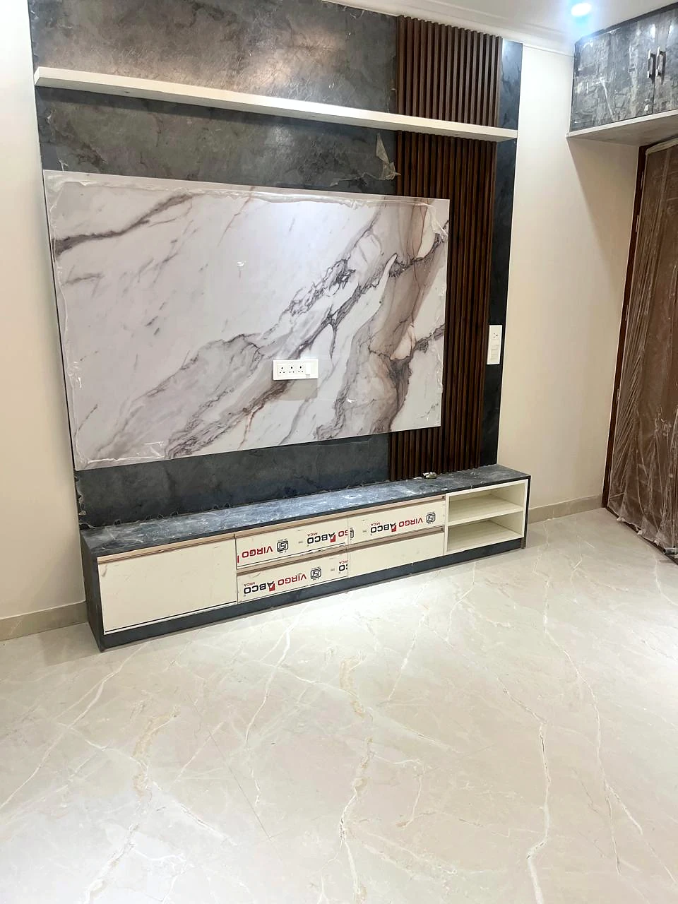 Low view of the media console, stone-look wall and finished floor