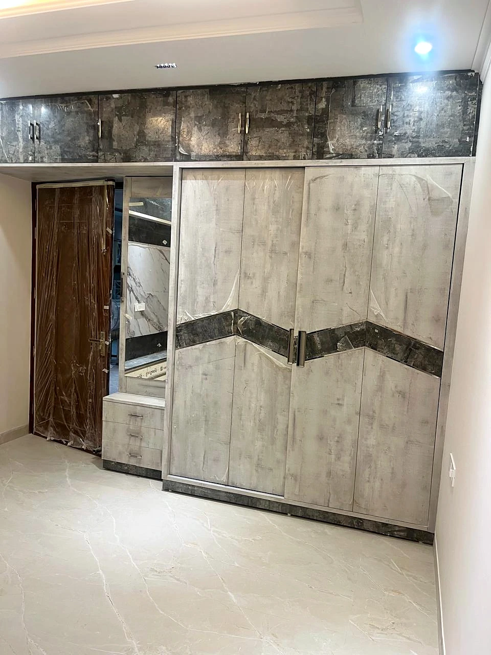 Full-height wardrobe with coordinated dark accent detailing
