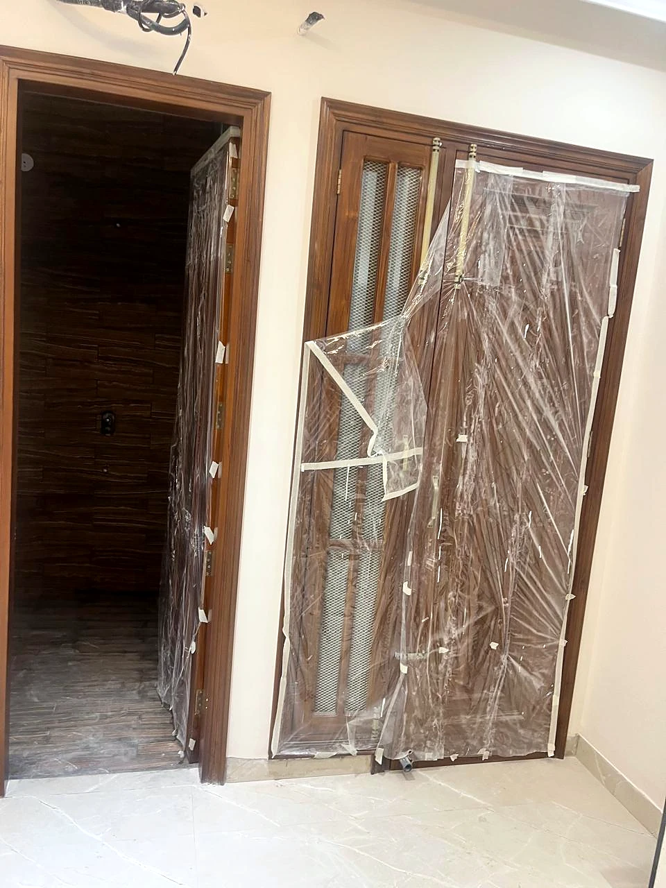 Timber door installation in progress at the residence