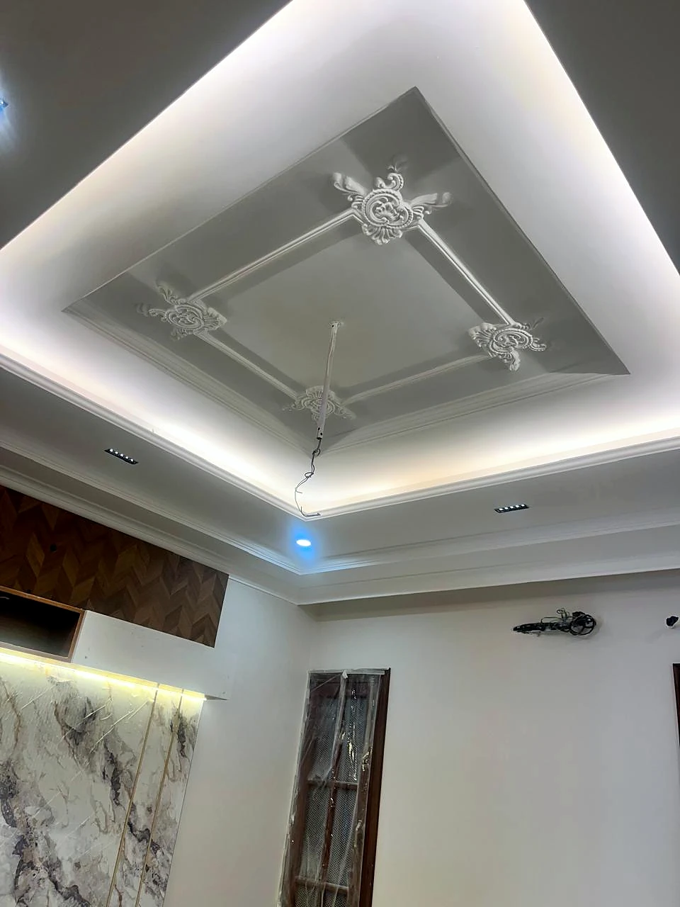 Ceiling center panel with fan and surrounding cove lighting