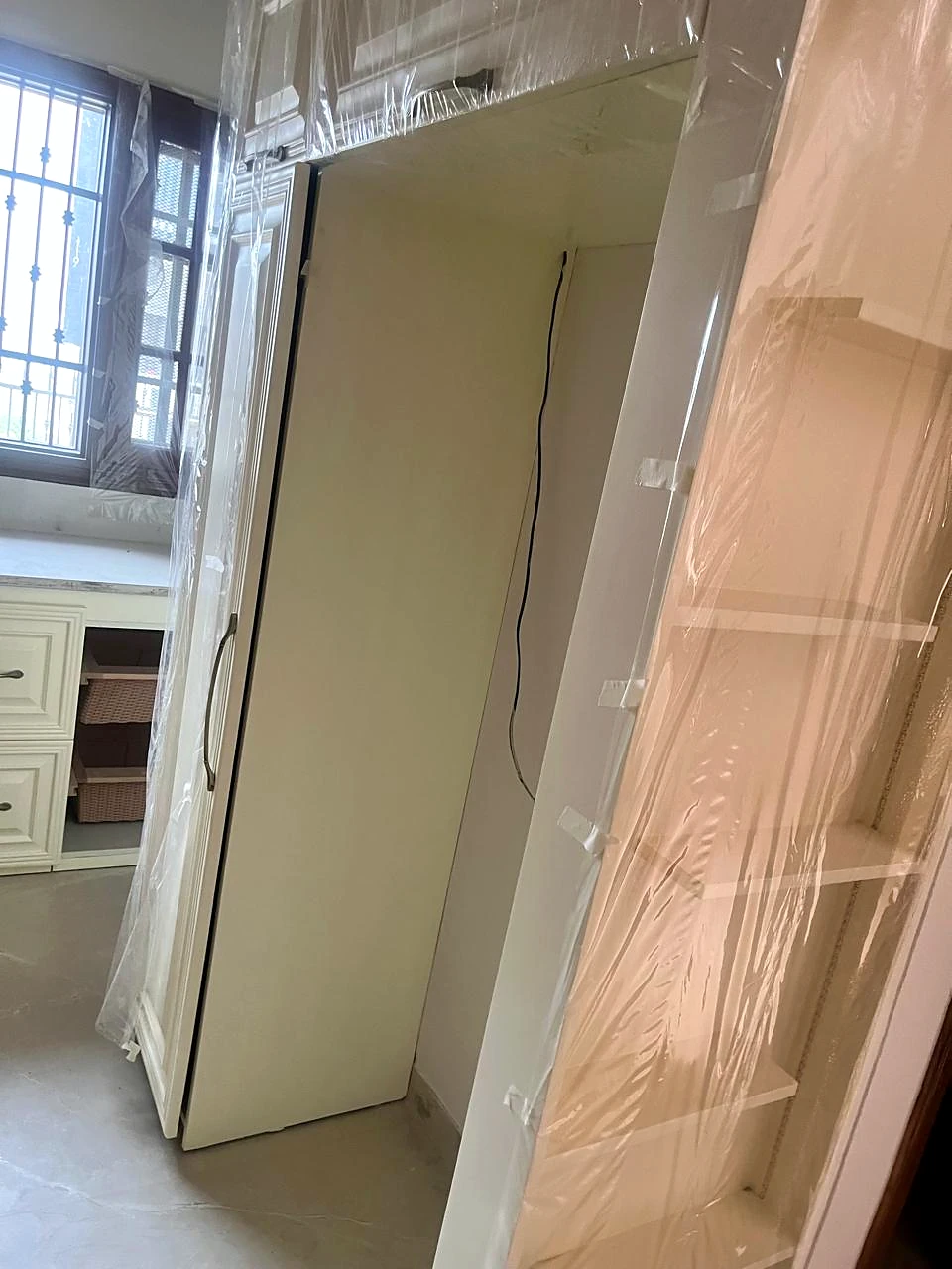 Kitchen partition and tall appliance niche viewed from the counter