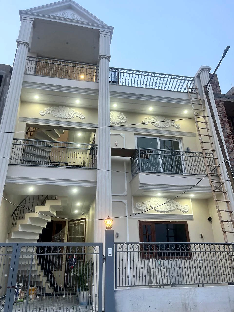 Street-facing view of the Sector 123 kothi with exterior lighting