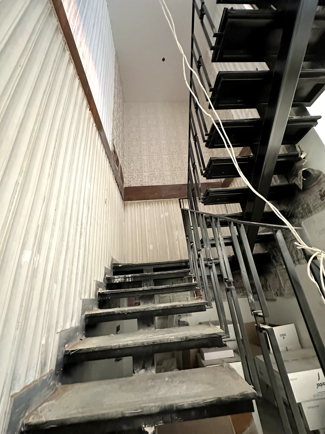 Staircase installation progressing beside the feature window