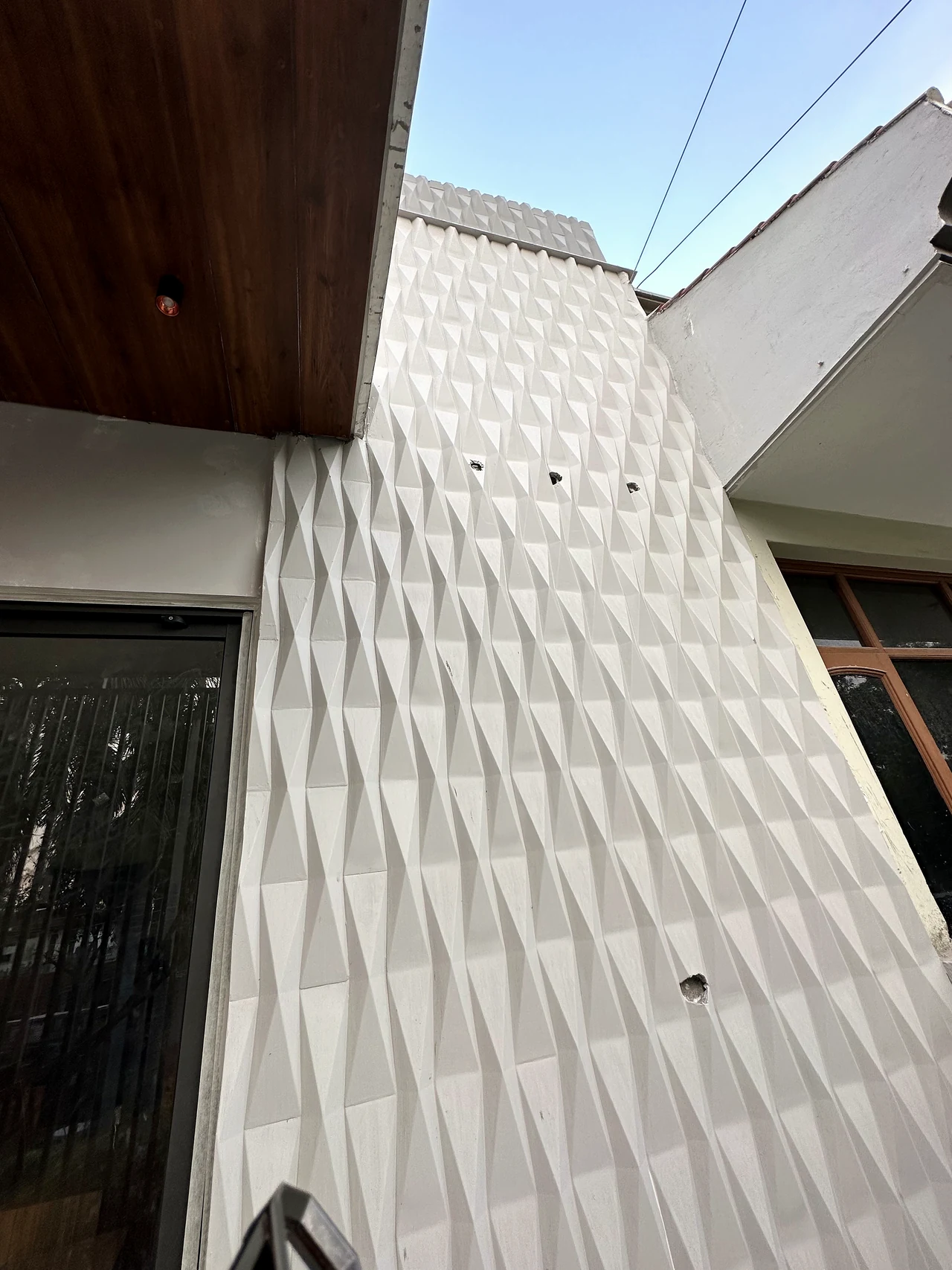 Geometric textured feature wall viewed from the balcony