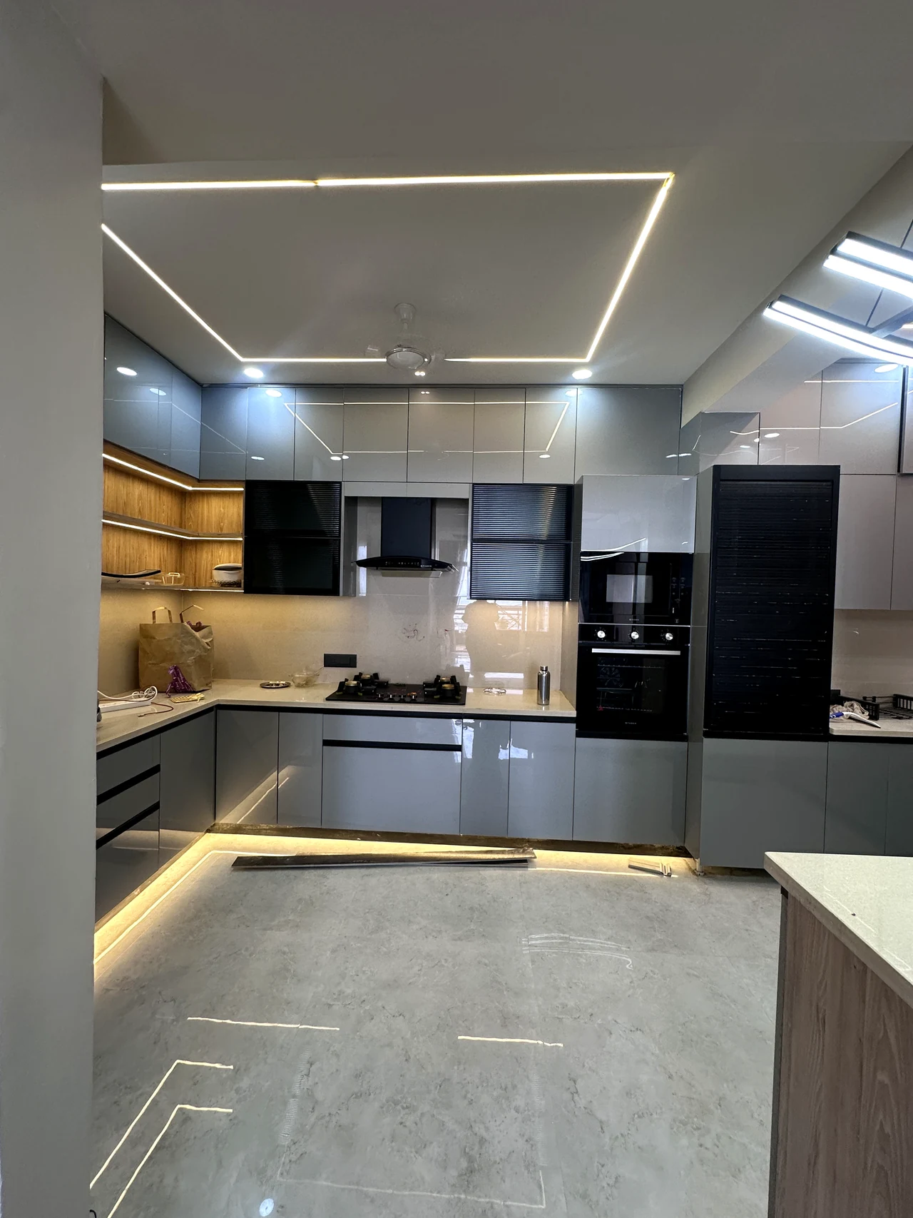 Wide view of the modular kitchen, counter and ceiling lighting