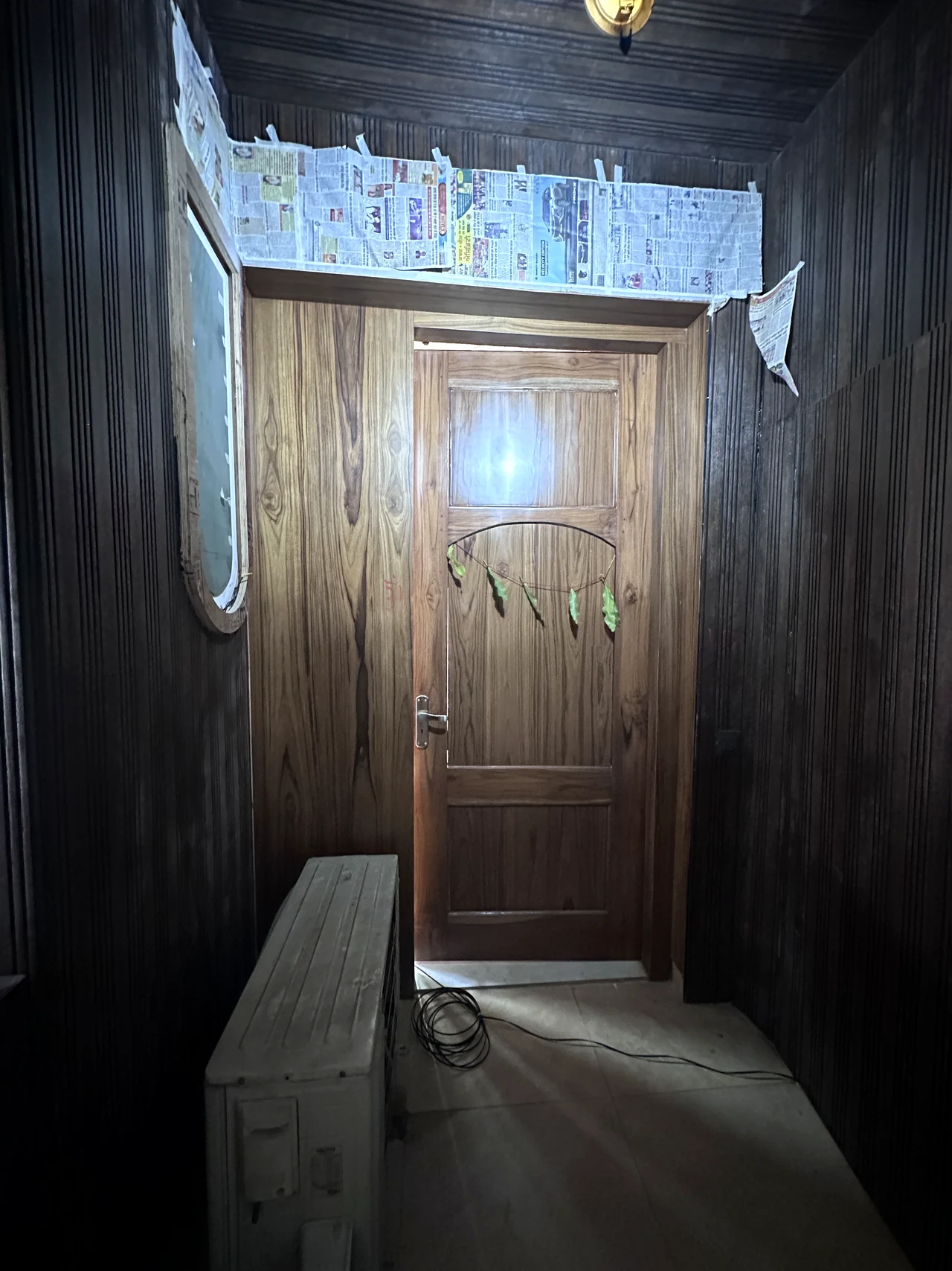 Dark timber-finish apartment entry door and foyer detail