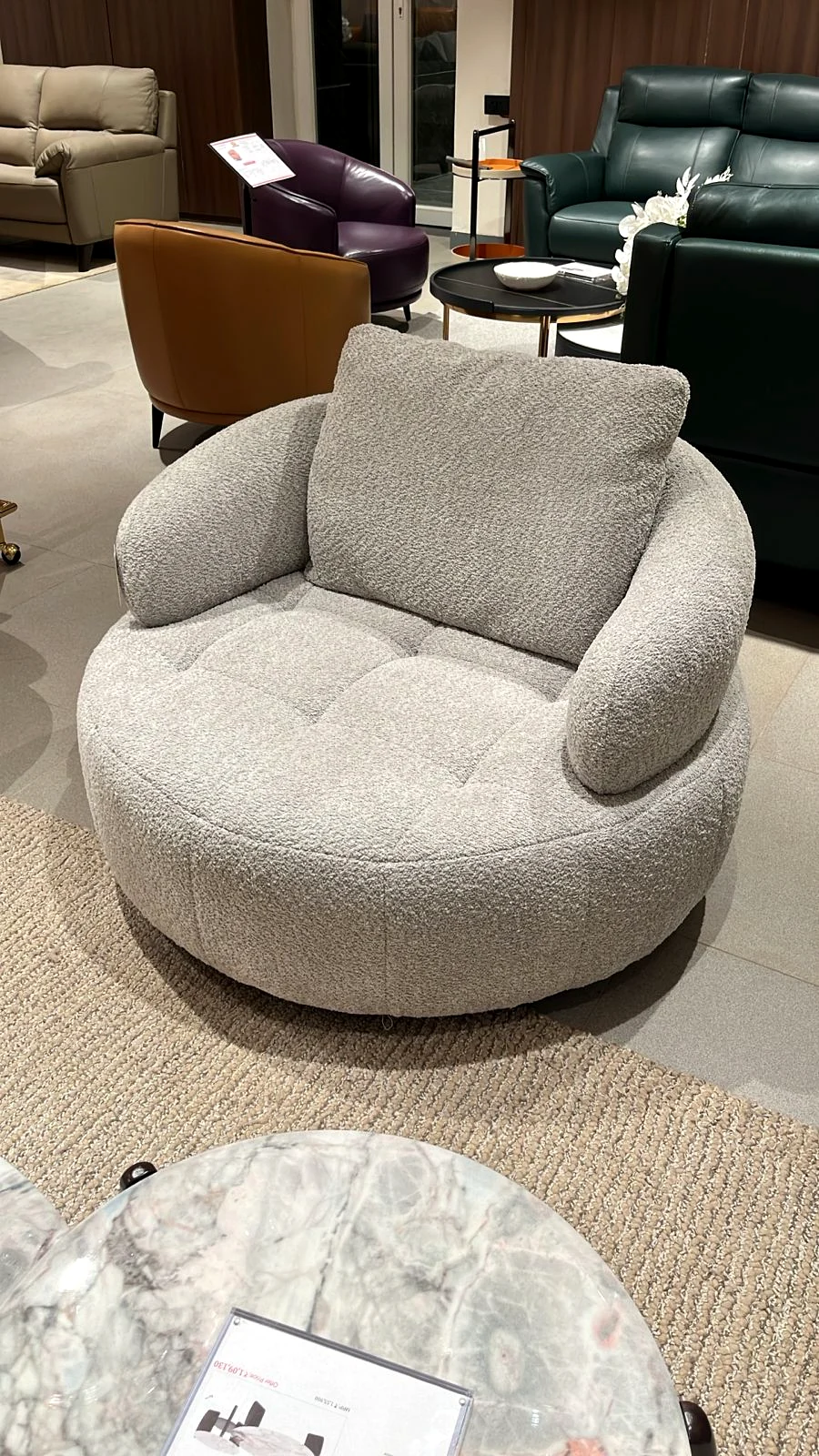 Curved lounge chair and rounded coffee table in the living area