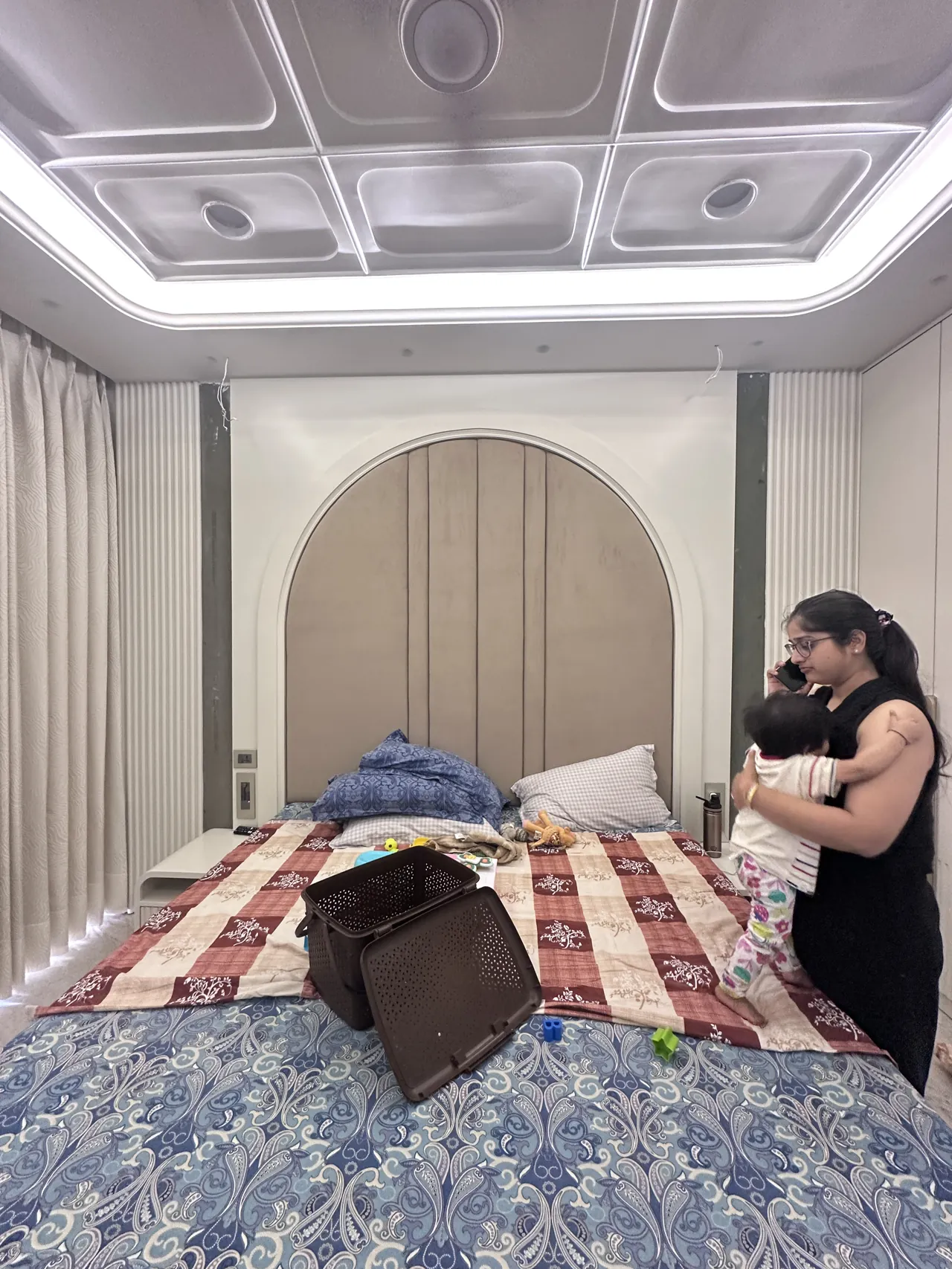 Bedroom feature wall and sculpted ceiling in a lived-in view